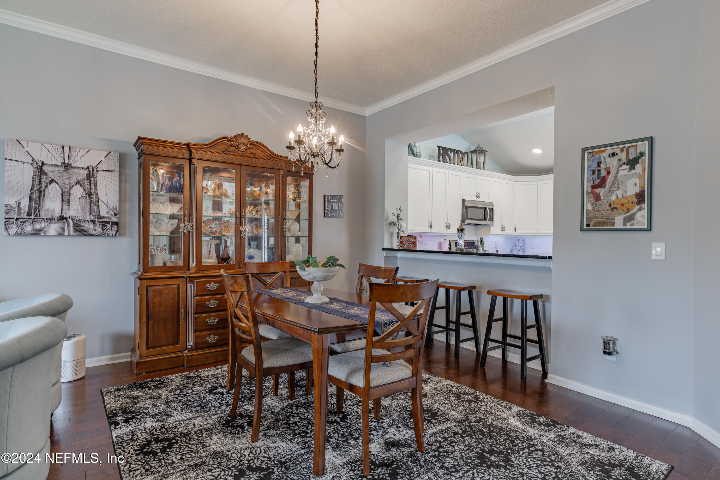 1830 Copper Stone Drive, Unit D Fleming Island, FL 32003 - Photo 13 of 65 a view of a dining room with furniture and chandelier