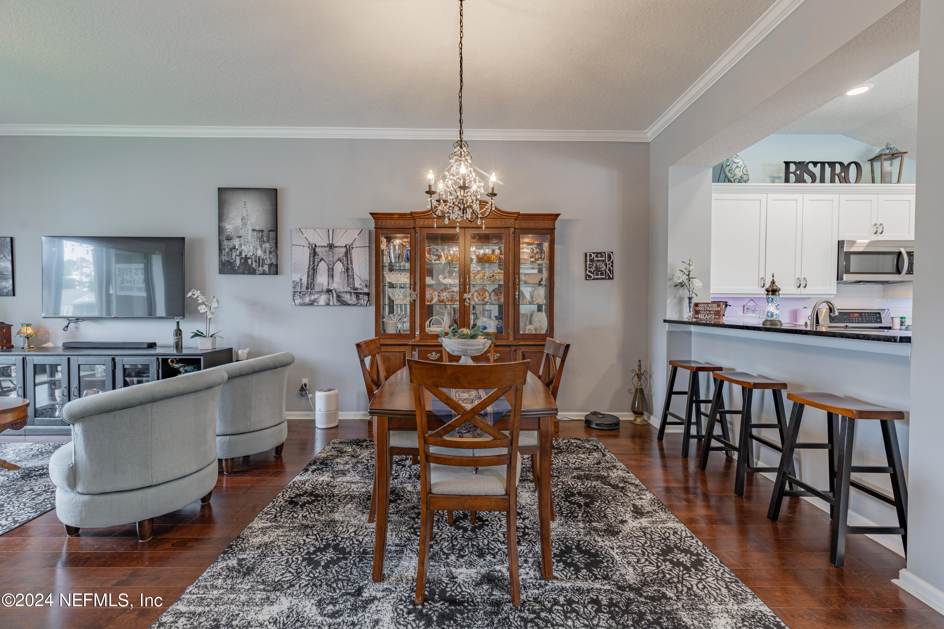 1830 Copper Stone Drive, Unit D Fleming Island, FL 32003 - Photo 14 of 65 a dining room with furniture a chandelier and wooden floor