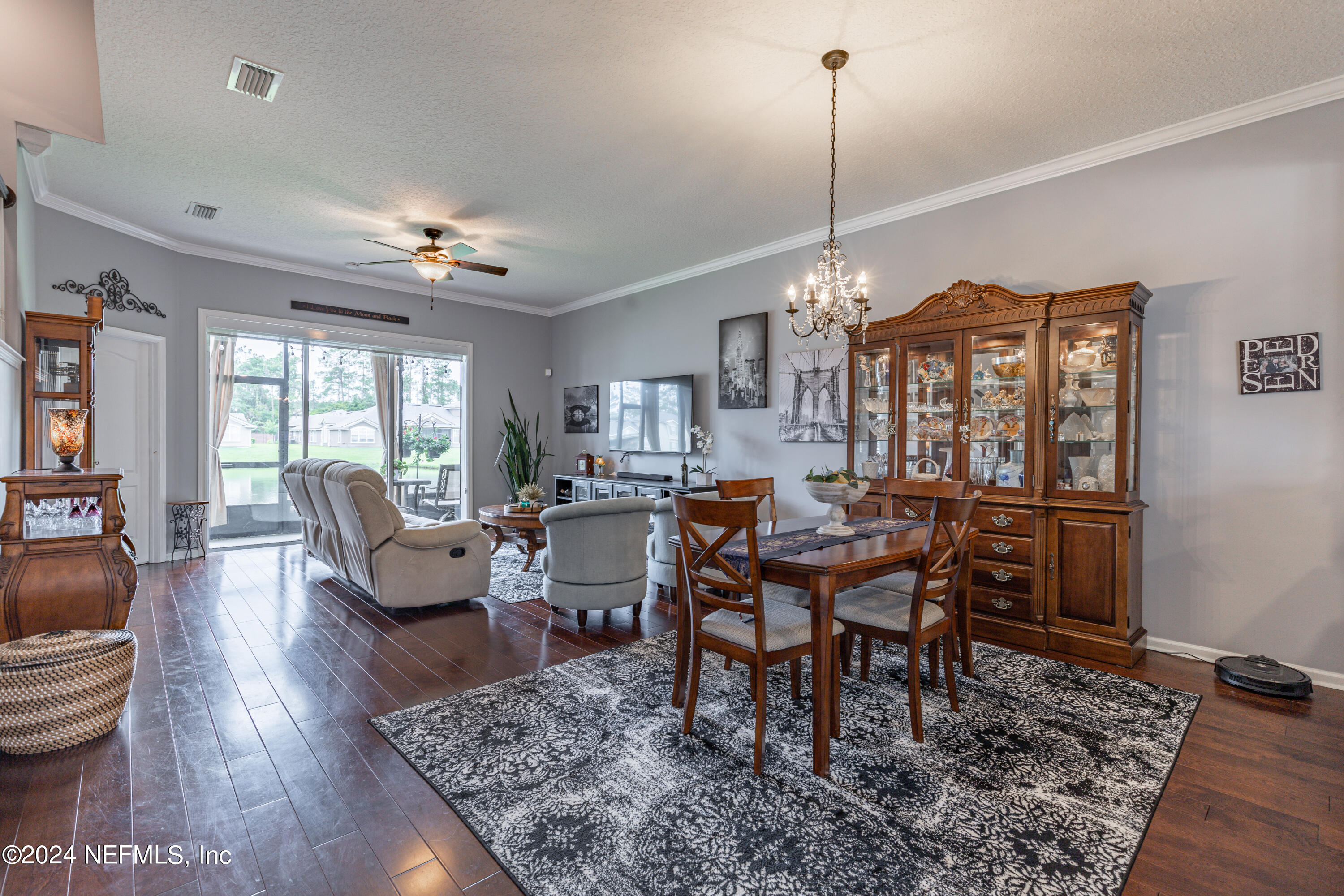 1830 Copper Stone Drive, Unit D Fleming Island, FL 32003 - Photo 15 of 65 a view of a dining room with furniture window and wooden floor