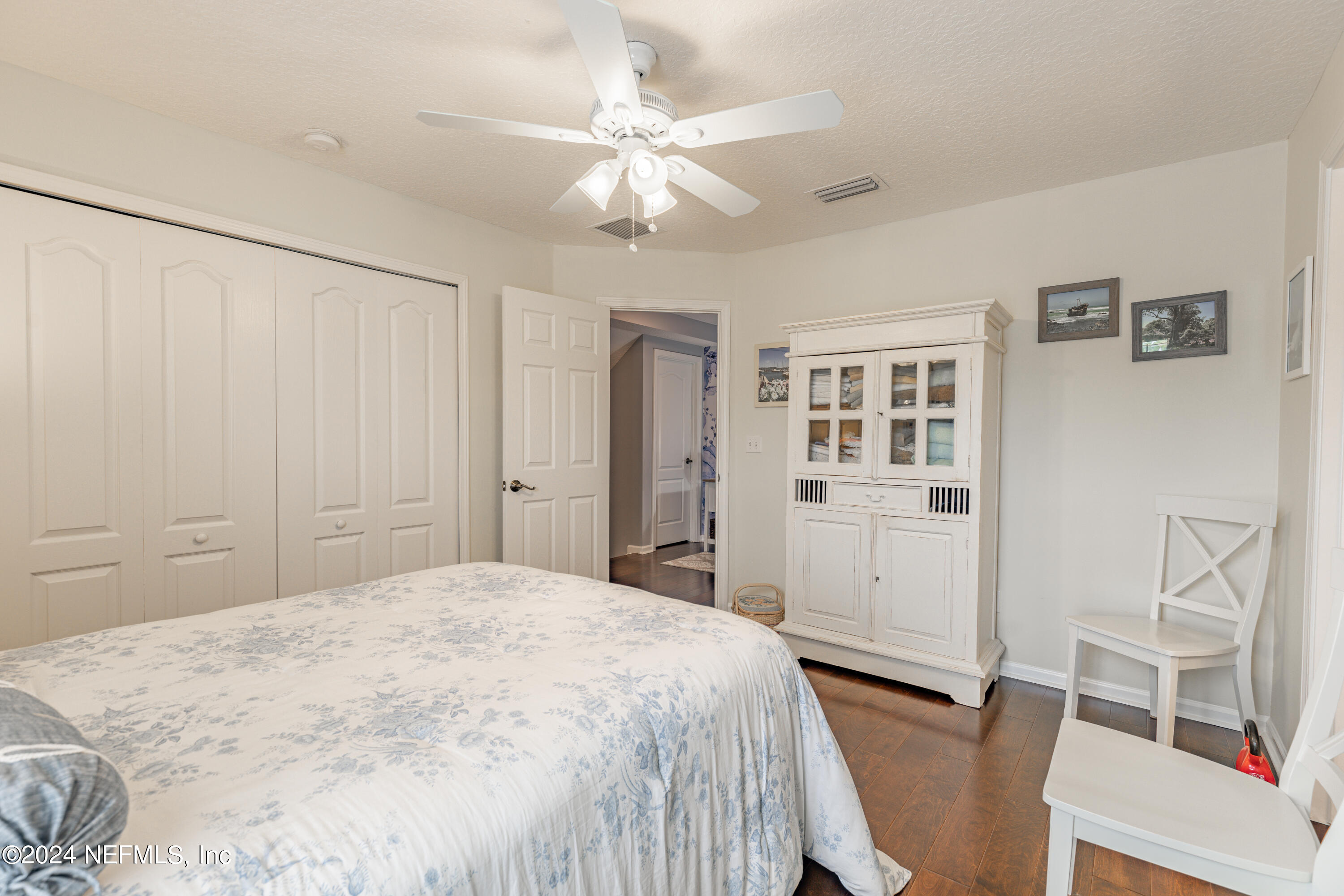 1830 Copper Stone Drive, Unit D Fleming Island, FL 32003 - Photo 24 of 65 a spacious bedroom with a bed and a cabinets