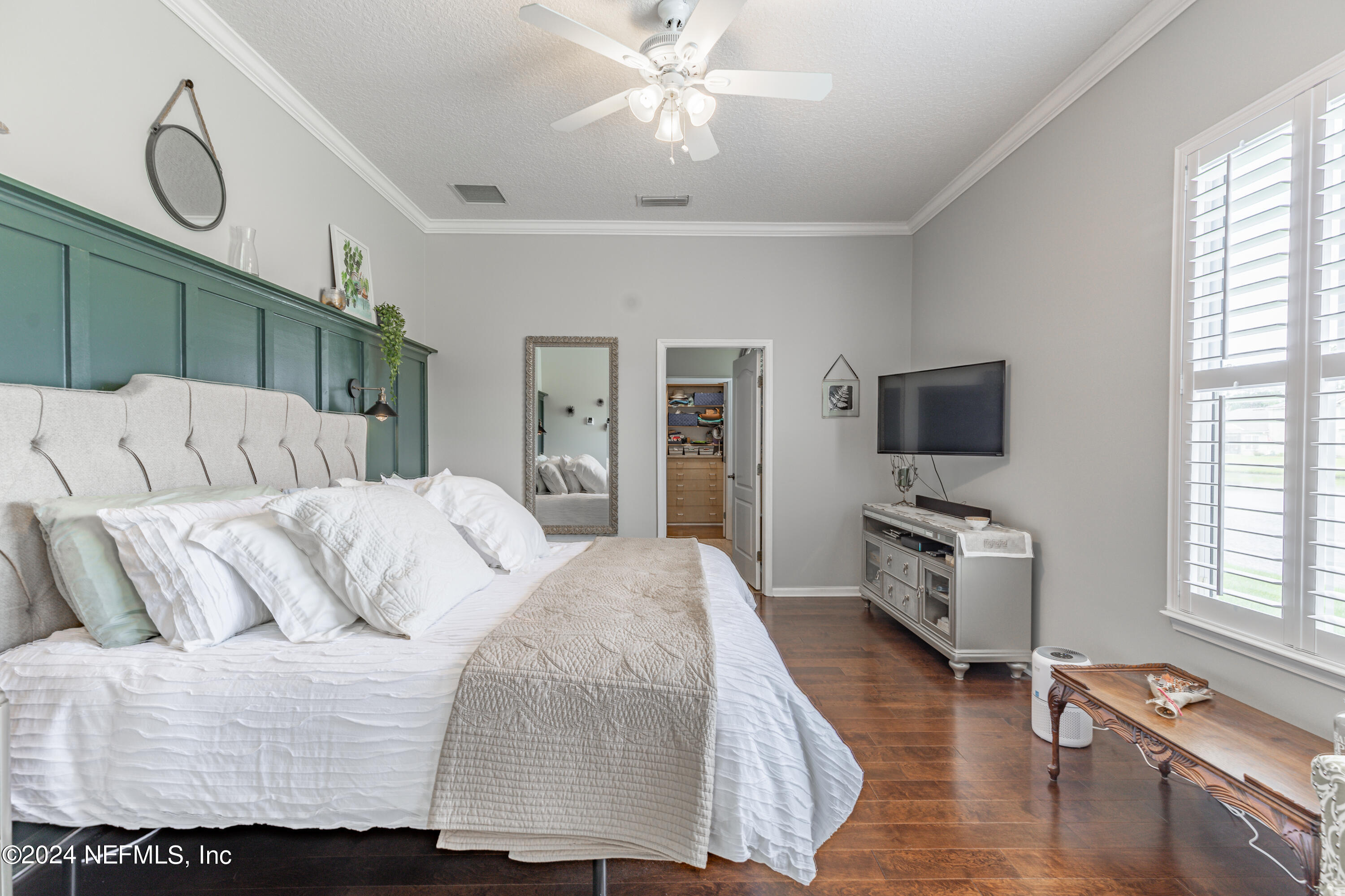 1830 Copper Stone Drive, Unit D Fleming Island, FL 32003 - Photo 30 of 65 a living room with a bed furniture flat screen tv and windows