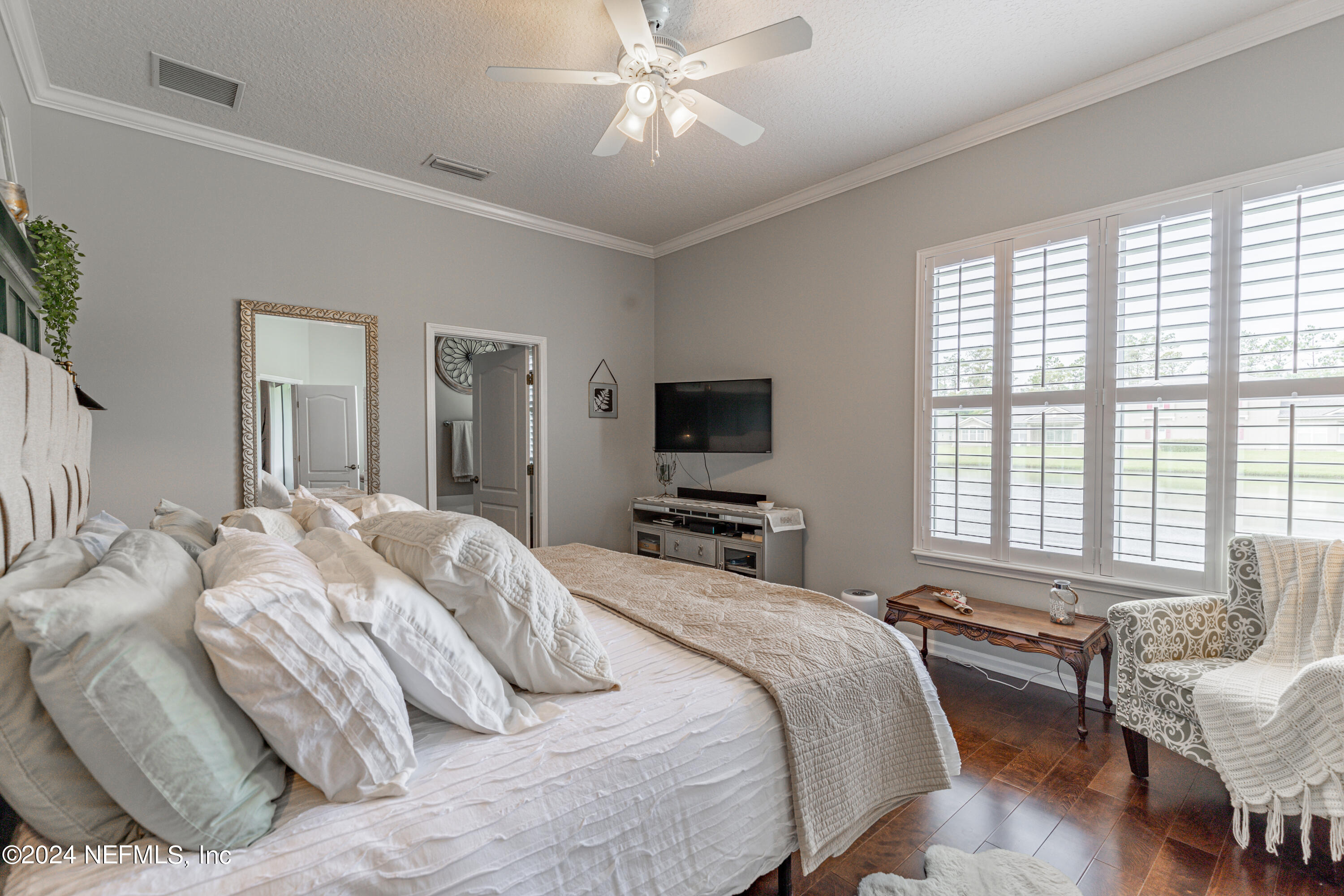 1830 Copper Stone Drive, Unit D Fleming Island, FL 32003 - Photo 31 of 65 a bedroom with a bed and a flat screen tv