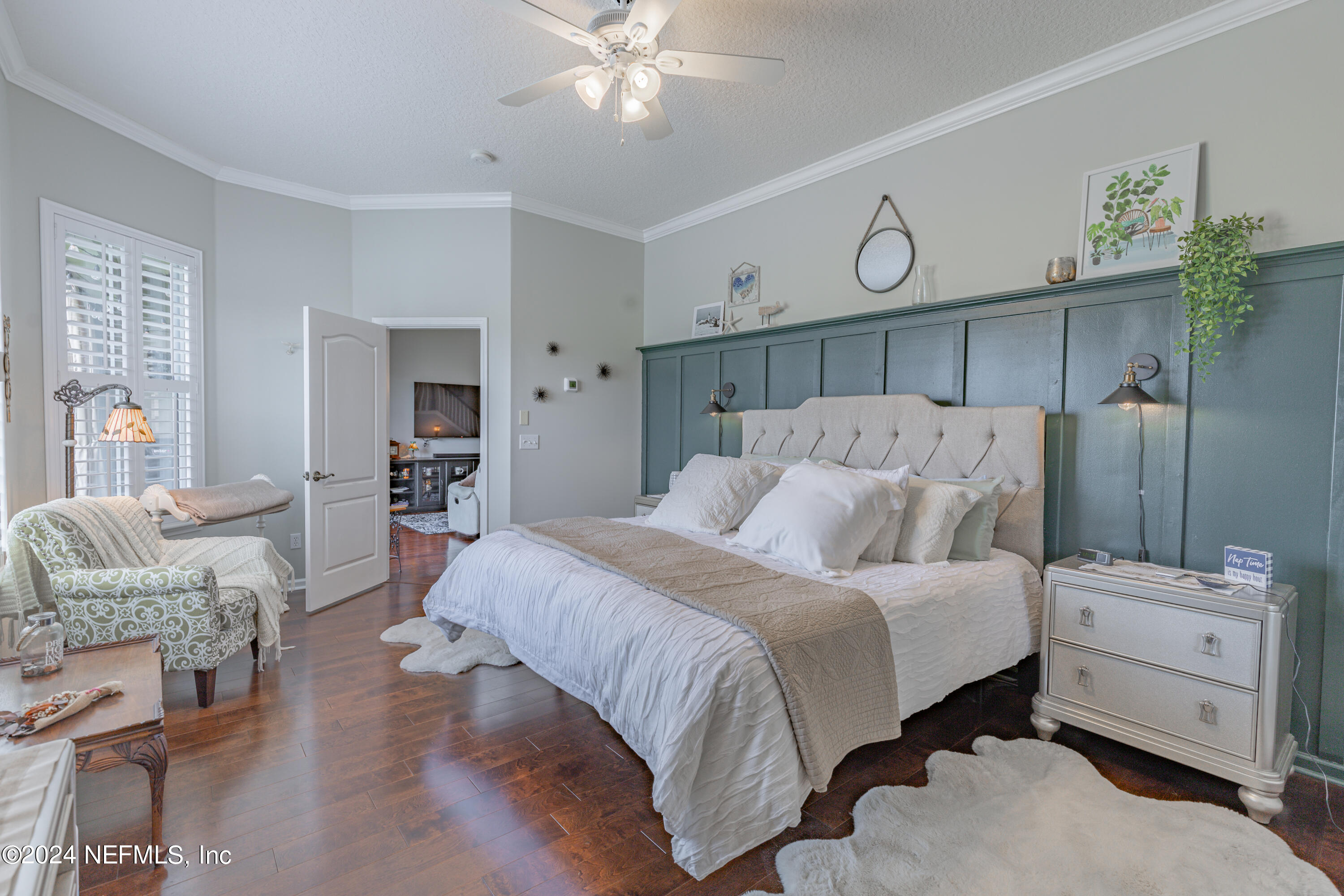 1830 Copper Stone Drive, Unit D Fleming Island, FL 32003 - Photo 32 of 65 a bedroom with a bed and a chandelier