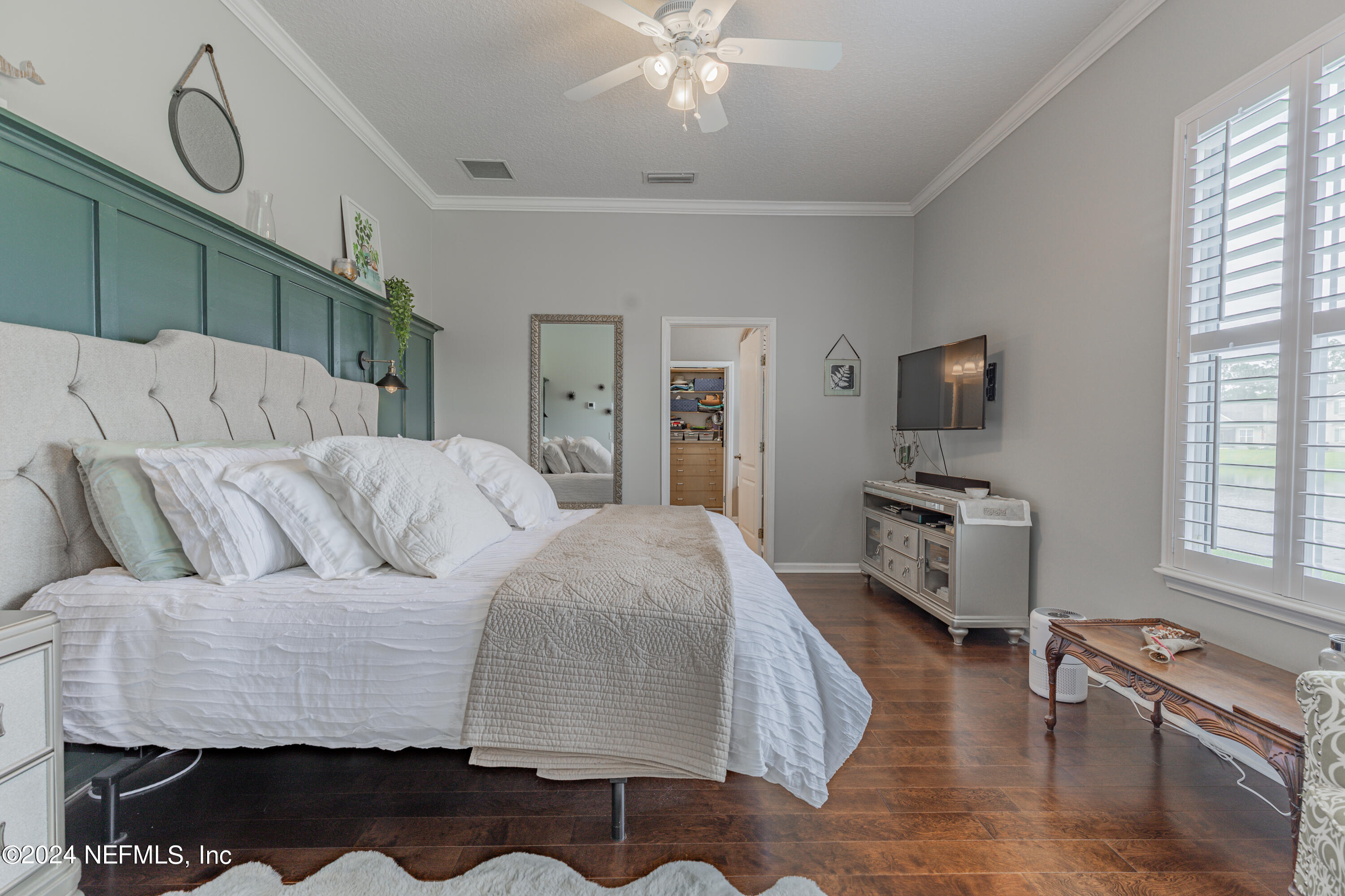 1830 Copper Stone Drive, Unit D Fleming Island, FL 32003 - Photo 33 of 65 a living room with a couch and a flat screen tv