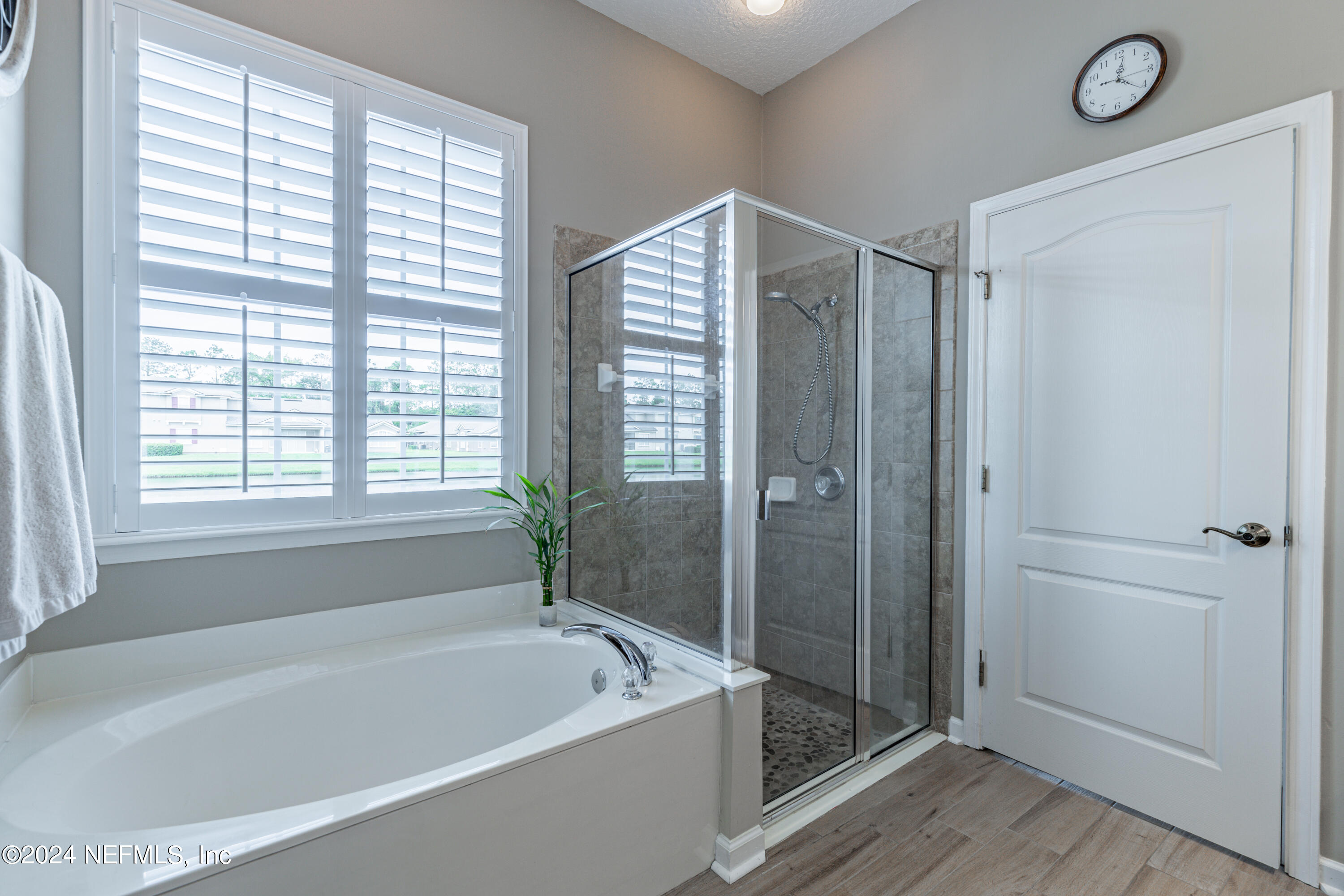 1830 Copper Stone Drive, Unit D Fleming Island, FL 32003 - Photo 35 of 65 a bathroom with a bathtub and a shower