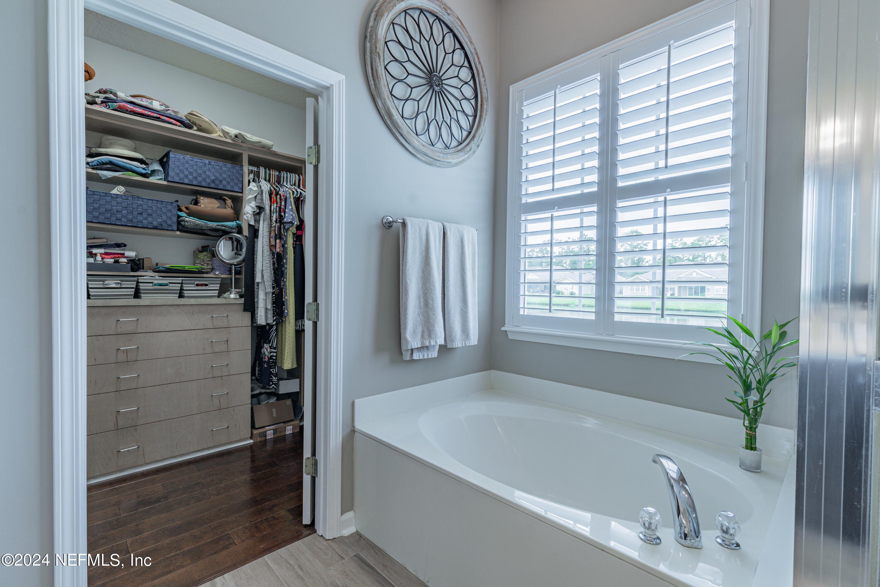 1830 Copper Stone Drive, Unit D Fleming Island, FL 32003 - Photo 37 of 65 a bathroom with a bathtub a shower and a window
