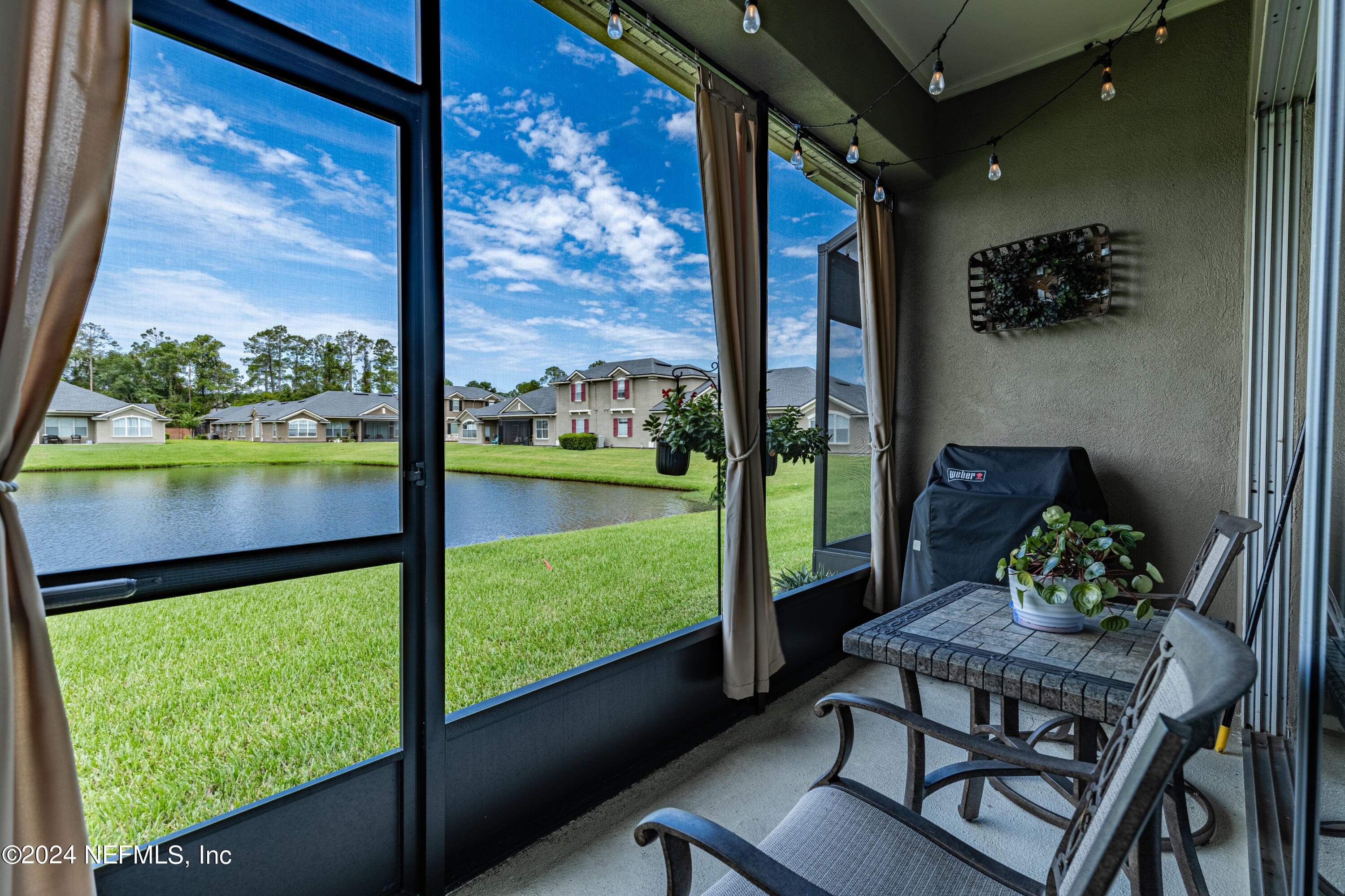 1830 Copper Stone Drive, Unit D Fleming Island, FL 32003 - Photo 39 of 65 a view of a porch with furniture and a yard