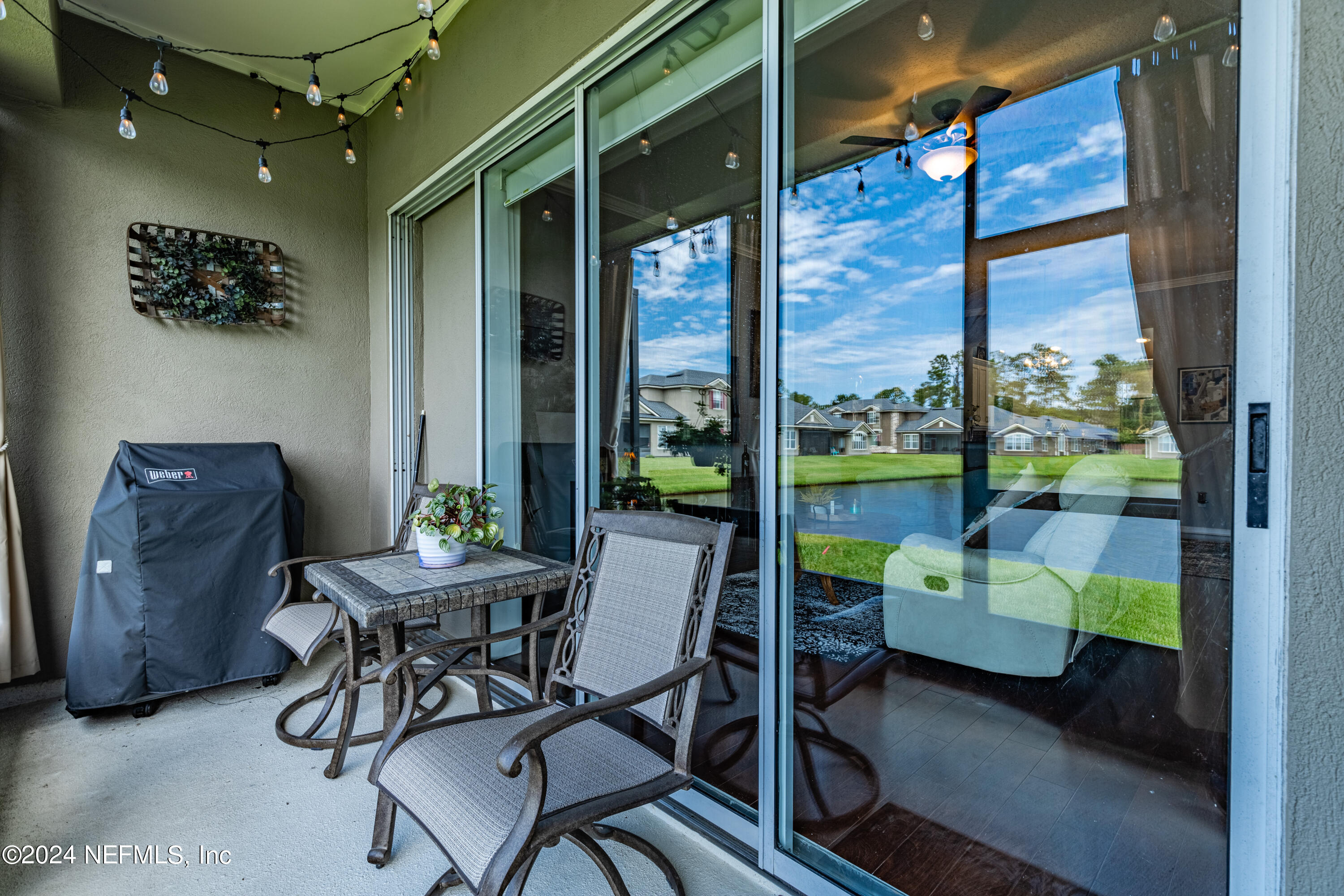 1830 Copper Stone Drive, Unit D Fleming Island, FL 32003 - Photo 40 of 65 a dining room with furniture and a floor to ceiling window