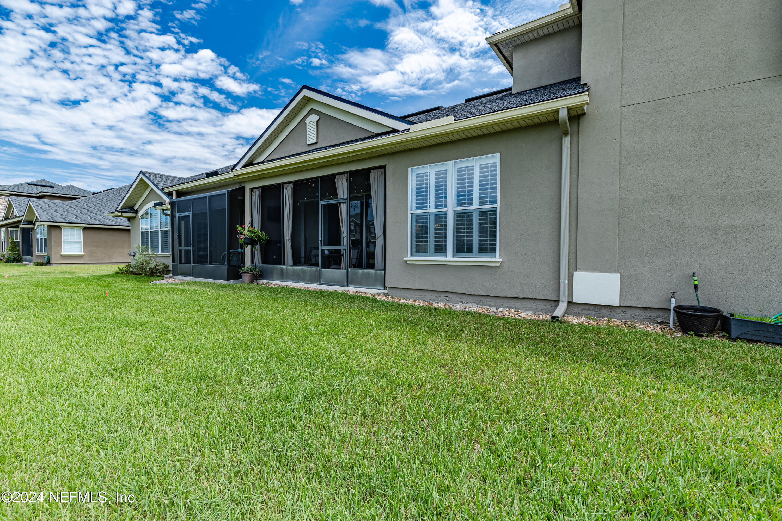 1830 Copper Stone Drive, Unit D Fleming Island, FL 32003 - Photo 42 of 65 a view of a house with garden and porch
