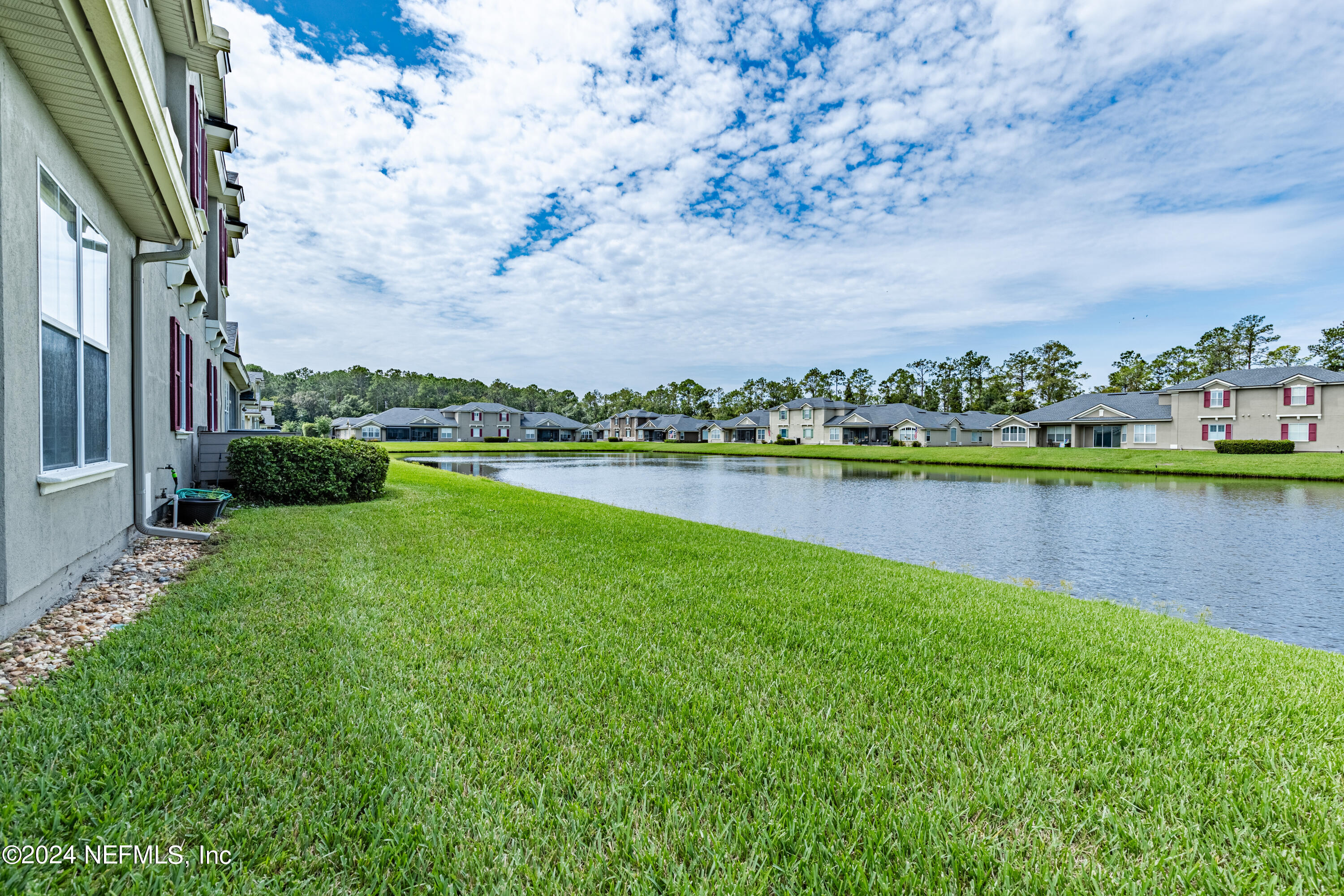 1830 Copper Stone Drive, Unit D Fleming Island, FL 32003 - Photo 43 of 65 a view of a lake with houses in the back