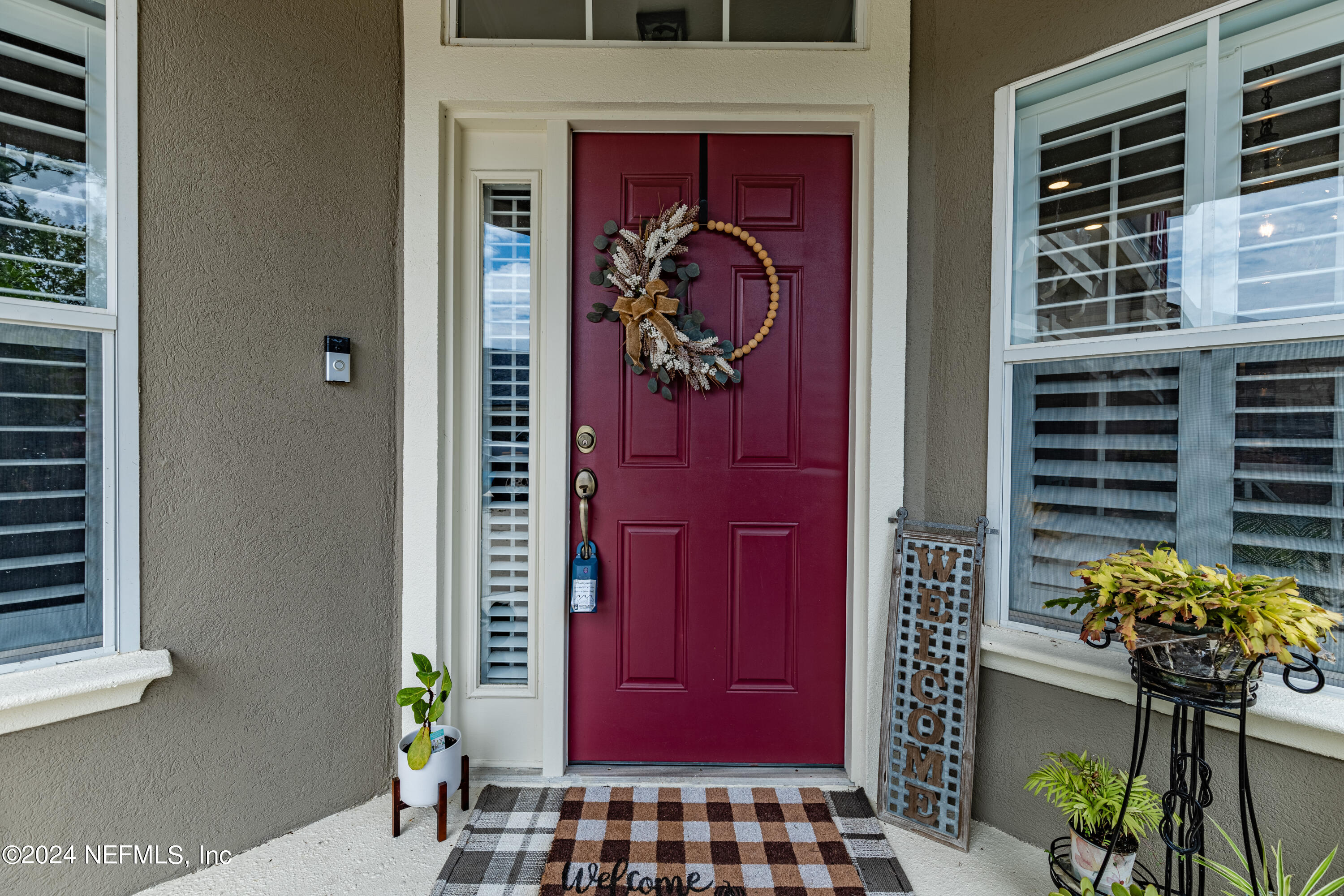1830 Copper Stone Drive, Unit D Fleming Island, FL 32003 - Photo 5 of 65 a front view of a house with a potted plant