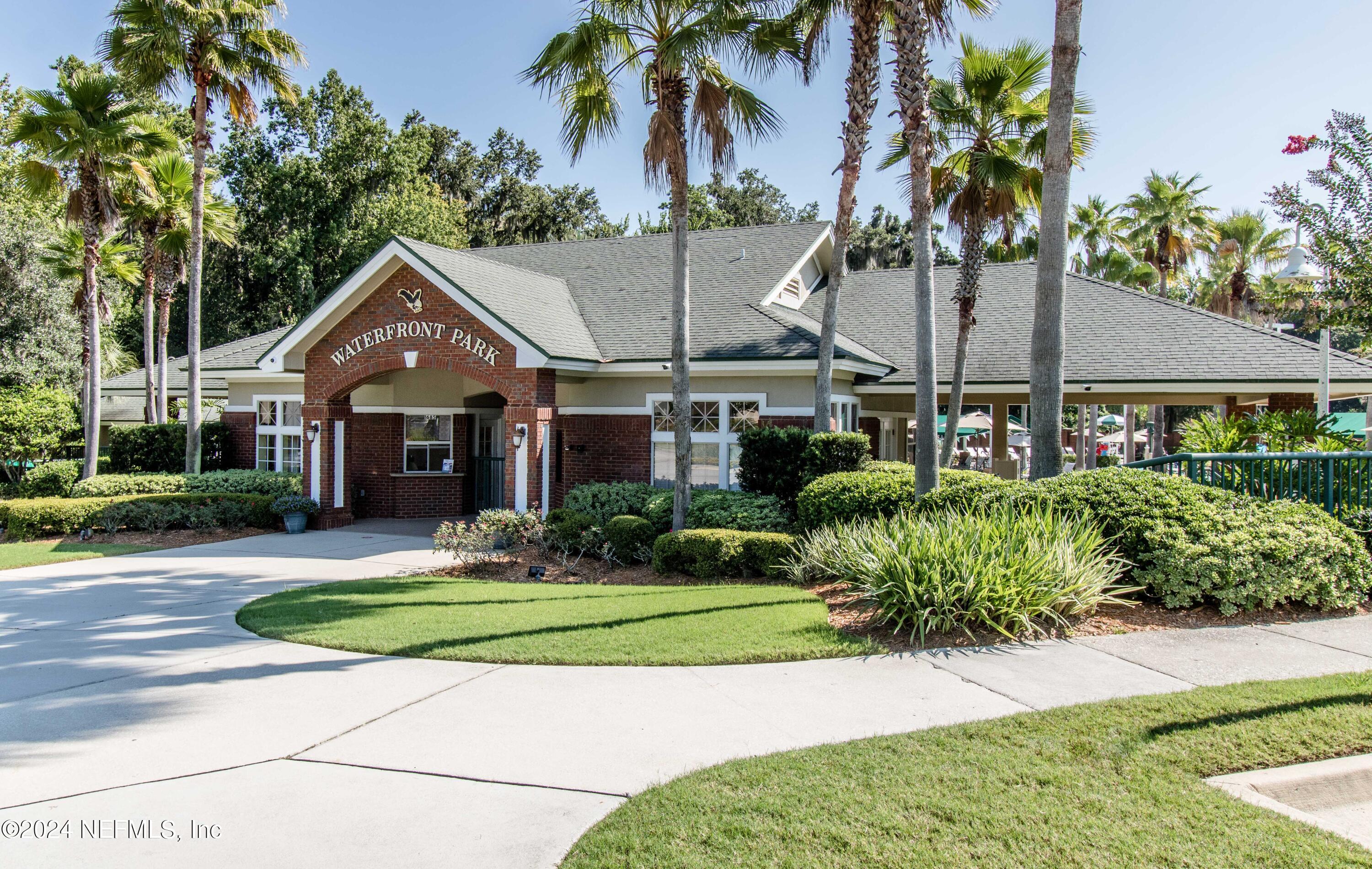 1830 Copper Stone Drive, Unit D Fleming Island, FL 32003 - Photo 65 of 65 a front view of a house with a yard and potted plants