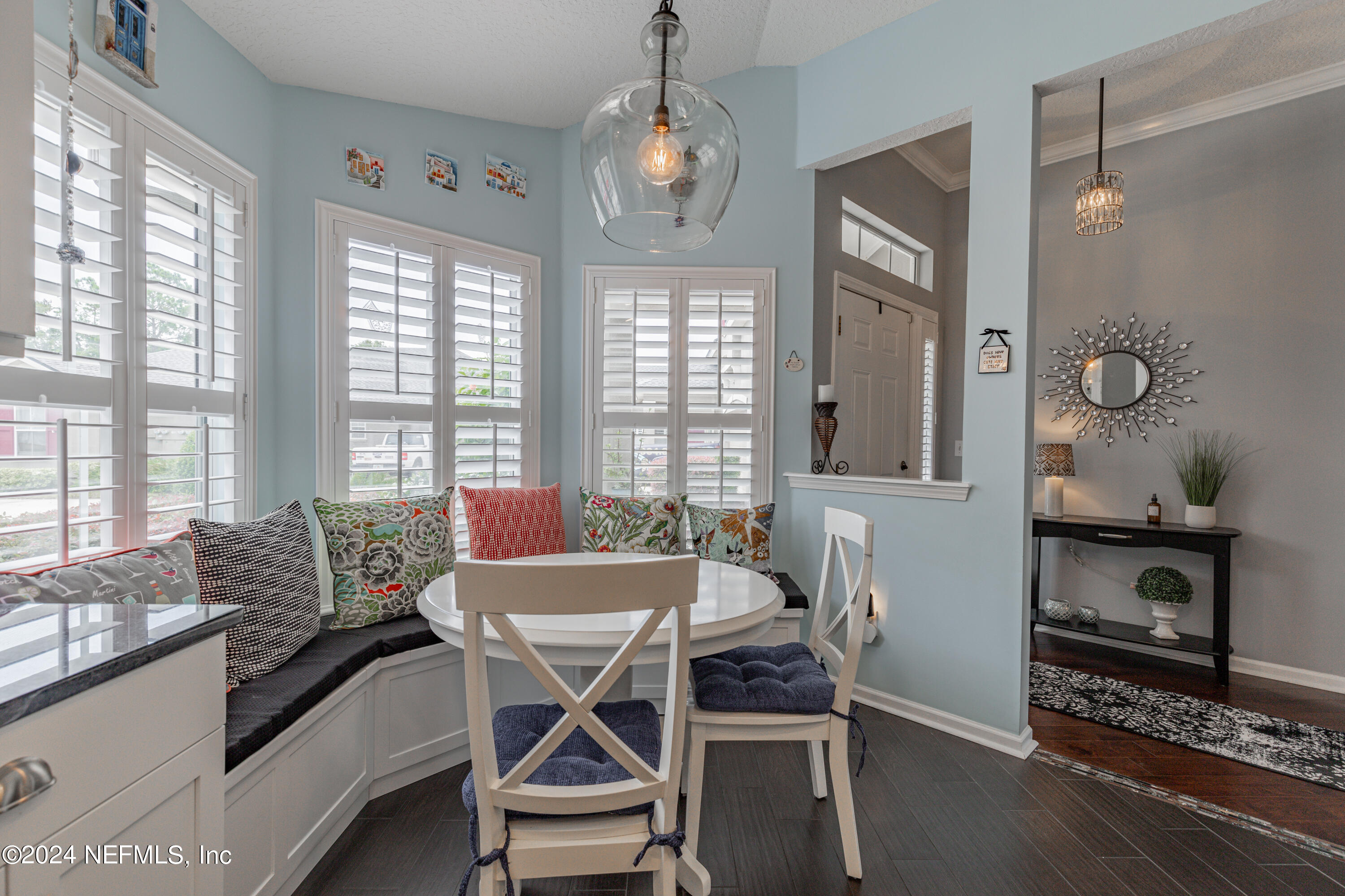 1830 Copper Stone Drive, Unit D Fleming Island, FL 32003 - Photo 7 of 65 a dining room with furniture a chandelier and wooden floor