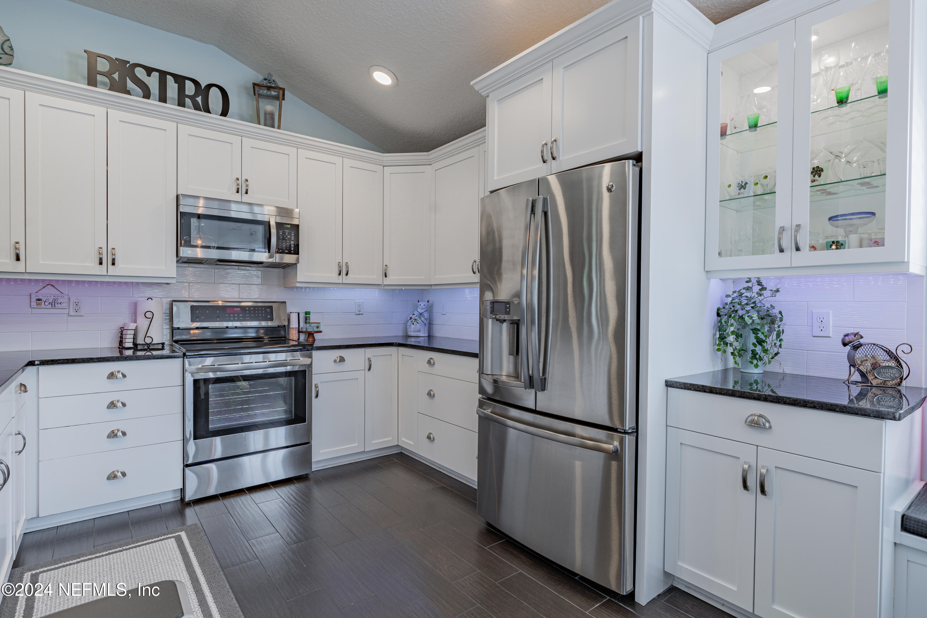 1830 Copper Stone Drive, Unit D Fleming Island, FL 32003 - Photo 8 of 65 a kitchen with stainless steel appliances a refrigerator stove and sink