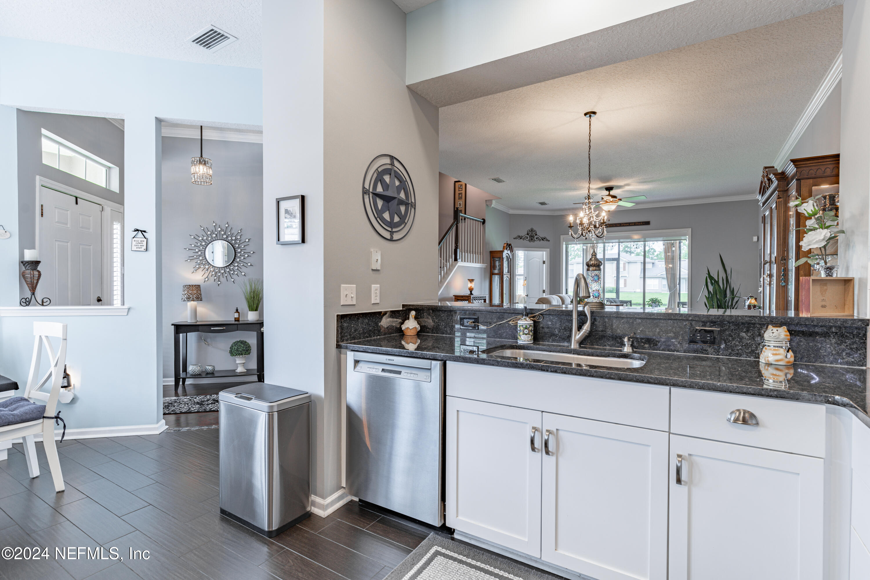 1830 Copper Stone Drive, Unit D Fleming Island, FL 32003 - Photo 10 of 65 a kitchen with granite countertop a sink and cabinets