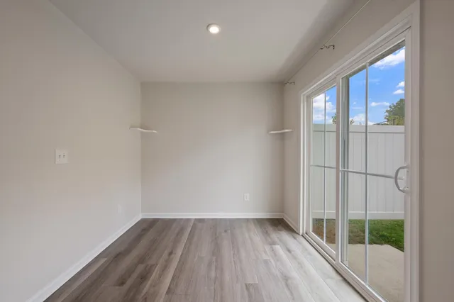 a view of wooden floor and windows in a room