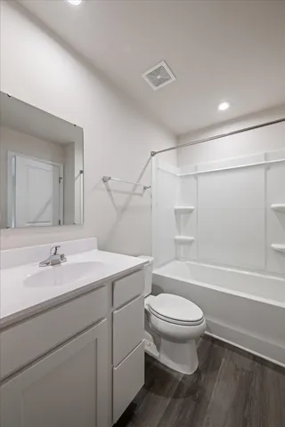 a bathroom with a sink a toilet and a large mirror