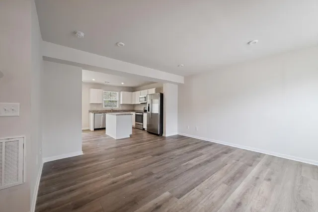 a view of a kitchen with wooden floor