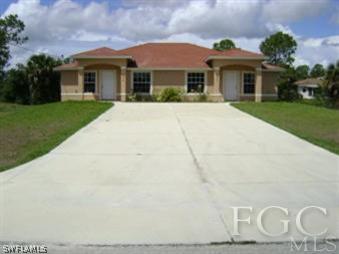 4944 Golfview Boulevard Lehigh Acres, FL 33973 - Photo 1 of 1 a front view of a house with a yard