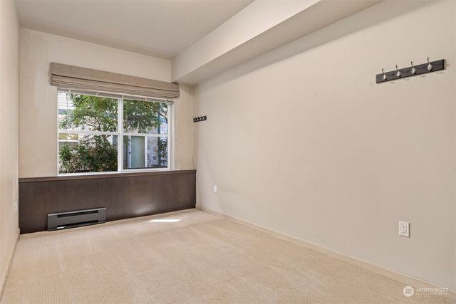 an empty room with wooden floor and a window