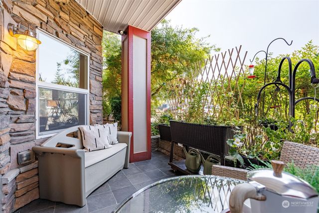 a living room filled with furniture and a floor to ceiling window