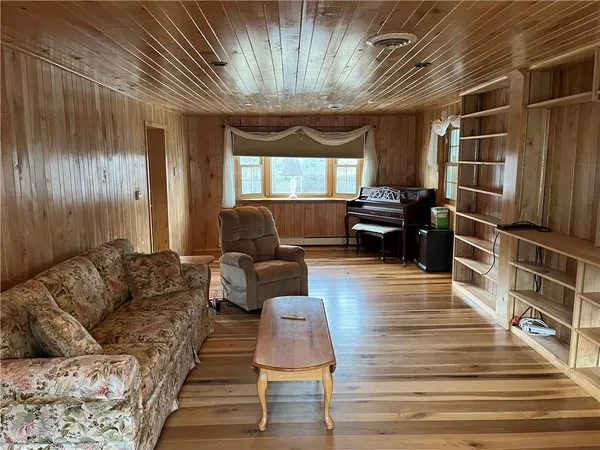 a living room with furniture windows and wooden floor