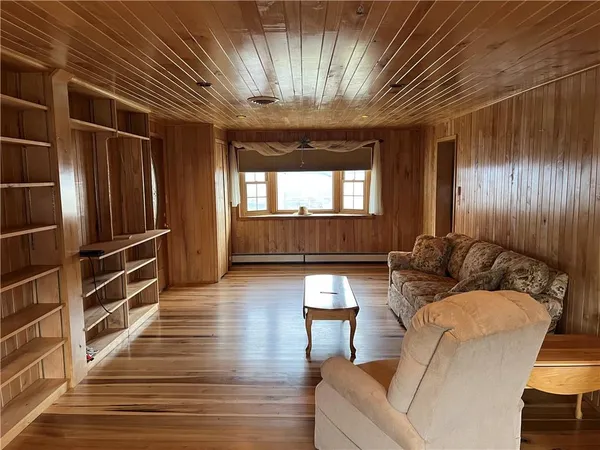 a living room with furniture a ceiling fan and a window