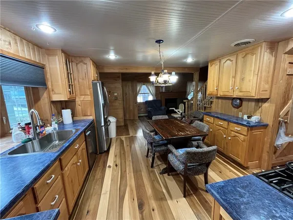 a living room with a couch and a dining table with wooden floor