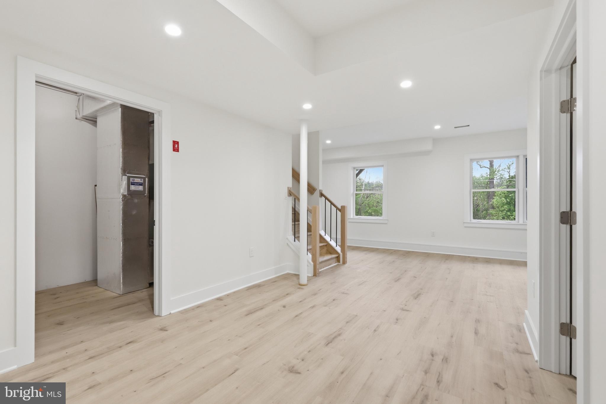 759 River Road Erwinna, PA 18920 - Photo 40 of 46 an empty room with wooden floor staircase and windows
