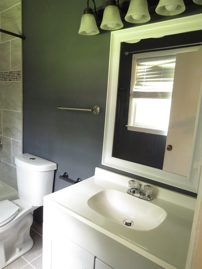 4212 Curry Street Columbus, GA 31907 - Photo 11 of 13 a bathroom with a toilet sink and mirror