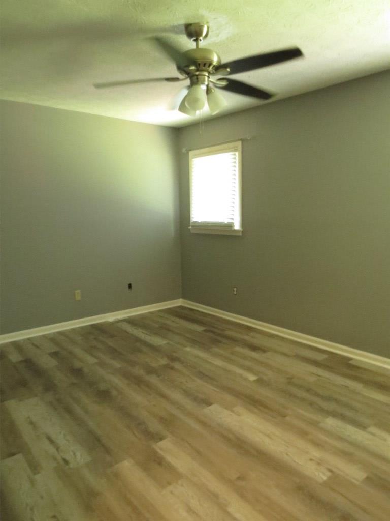 4212 Curry Street Columbus, GA 31907 - Photo 9 of 13 an empty room with a window and a fan