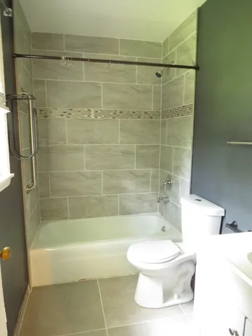 a bathroom with a toilet and a shower