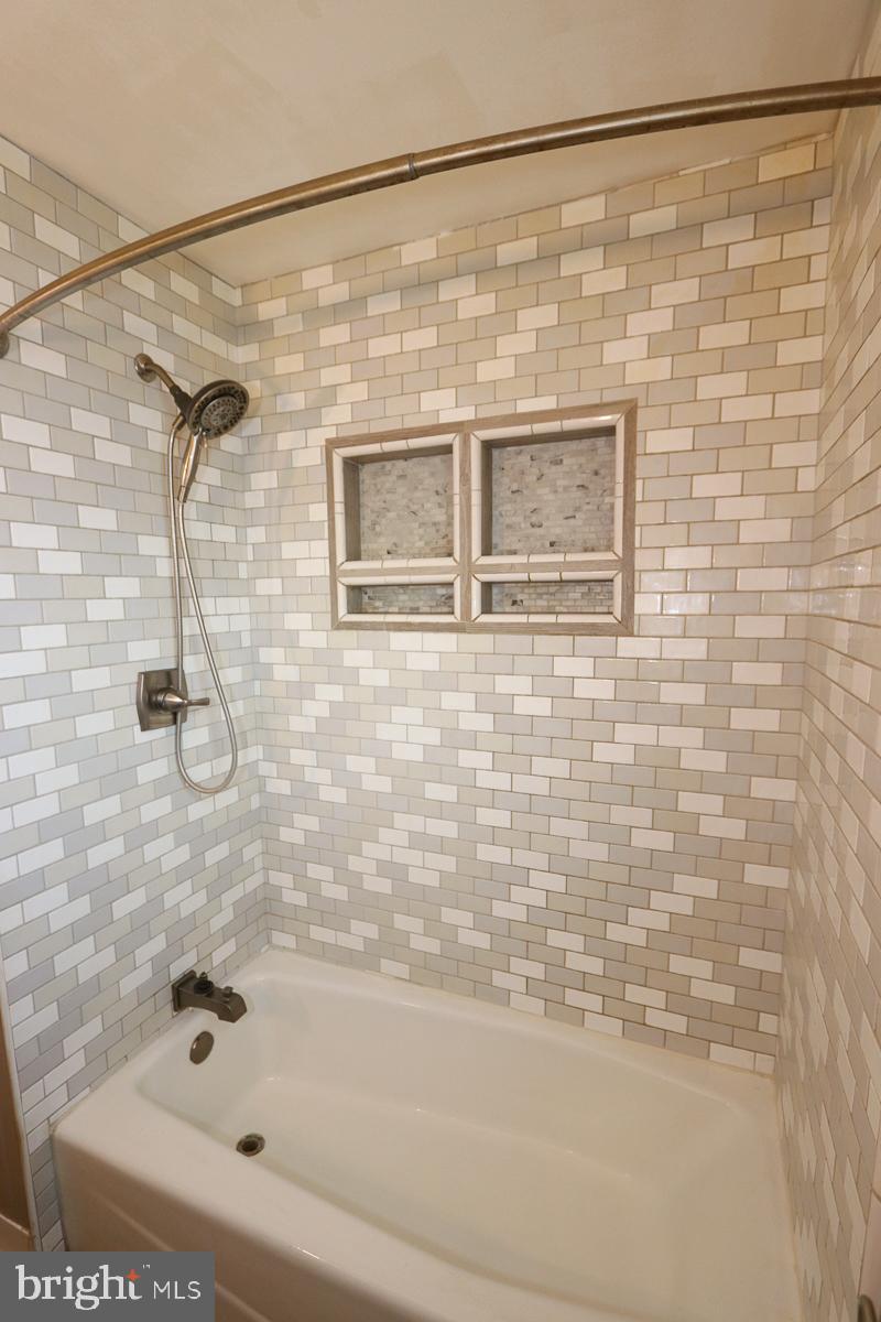 201 Castello Avenue Hatboro, PA 19040 - Photo 16 of 64 a bathroom with a shower and a bath tub