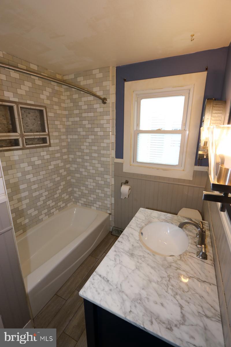 201 Castello Avenue Hatboro, PA 19040 - Photo 19 of 64 a bathroom with a granite countertop sink a toilet and bathtub