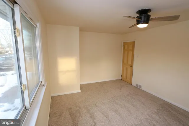 a view of an empty room with glass door