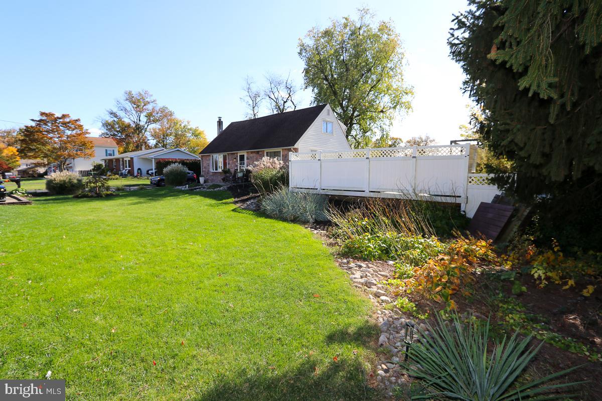 201 Castello Avenue Hatboro, PA 19040 - Photo 2 of 64 a backyard of a house with table and chairs plants and large tree