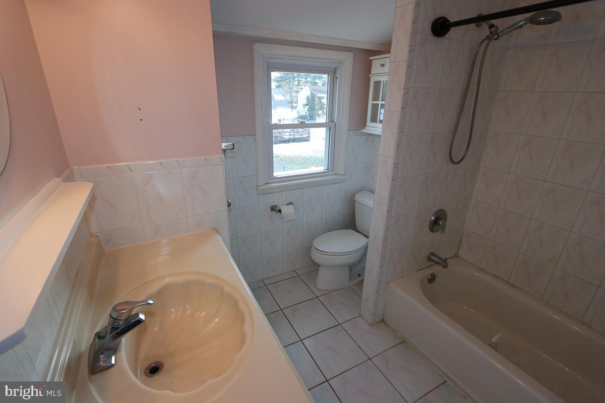 201 Castello Avenue Hatboro, PA 19040 - Photo 39 of 64 a bathroom with a sink a toilet and shower