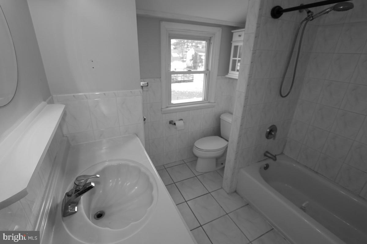 201 Castello Avenue Hatboro, PA 19040 - Photo 40 of 64 a bathroom with a sink a toilet and shower