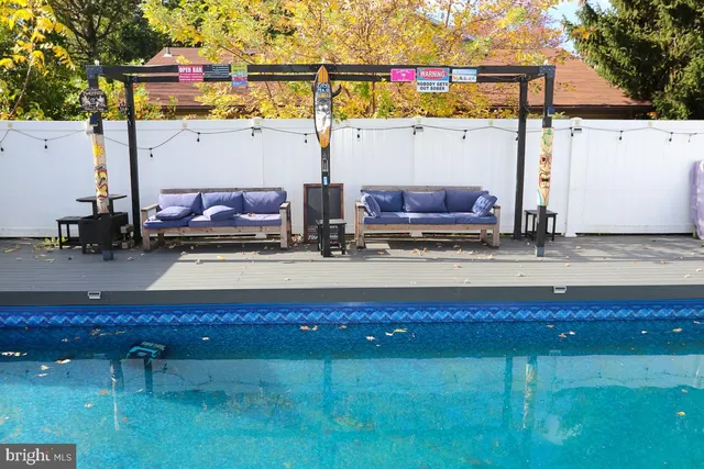 a view of house with backyard and outdoor seating
