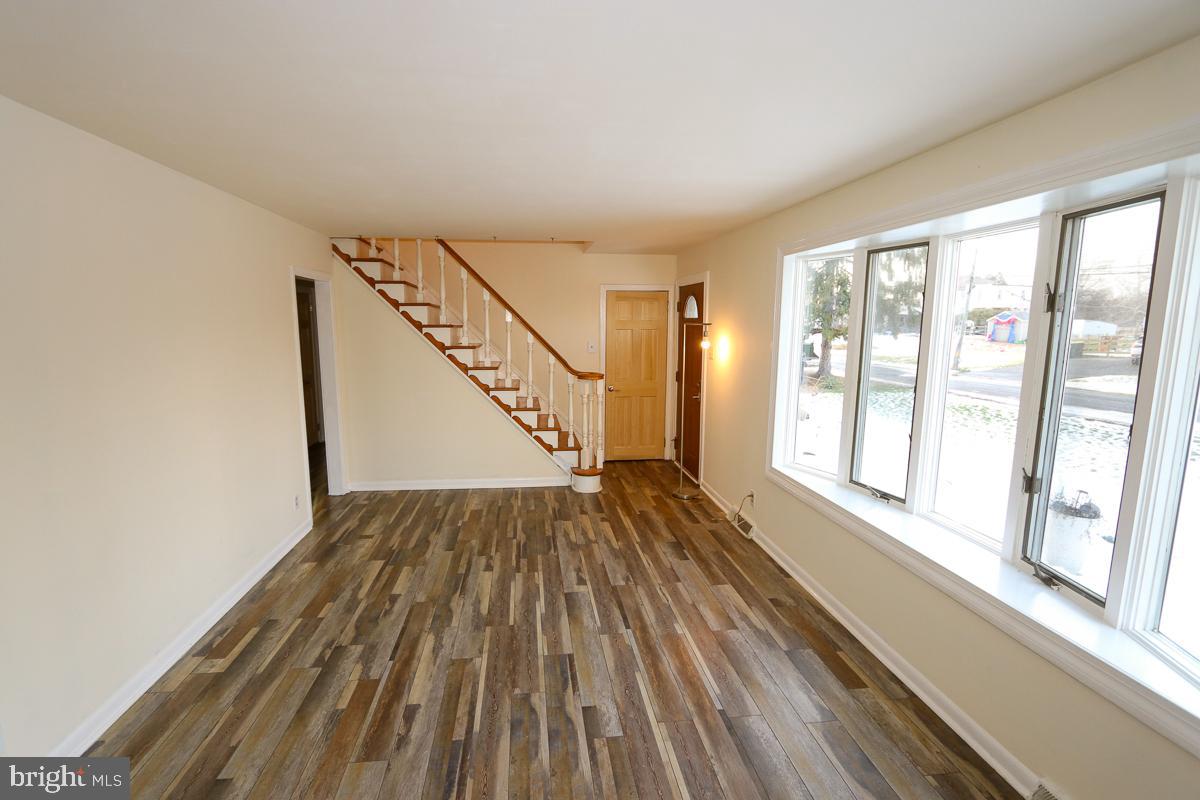 201 Castello Avenue Hatboro, PA 19040 - Photo 6 of 64 a view of an empty room with wooden floor and a window