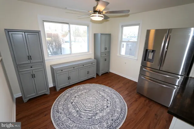 a kitchen with a refrigerator and a sink