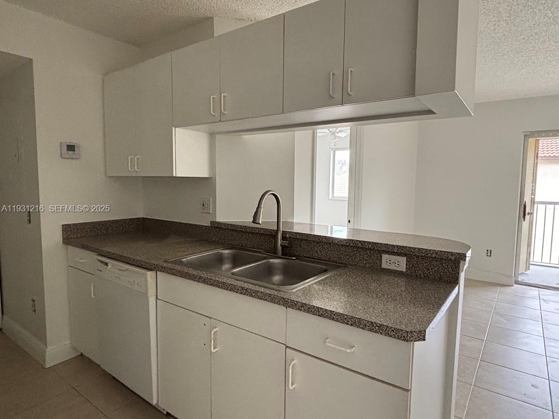 440 South Park Road, Unit 4303 Hollywood, FL 33021 - Photo 3 of 28 a kitchen with granite countertop a sink and cabinets