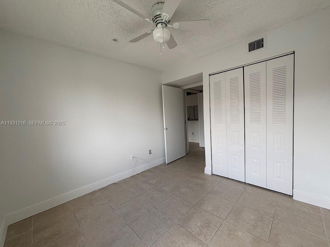 440 South Park Road, Unit 4303 Hollywood, FL 33021 - Photo 7 of 28 an empty room with a ceiling fan and carpet