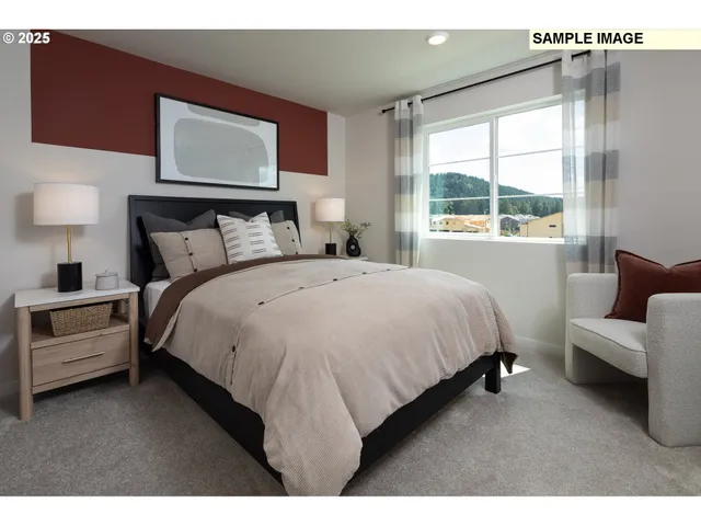 a large bed sitting in a bedroom next to a window