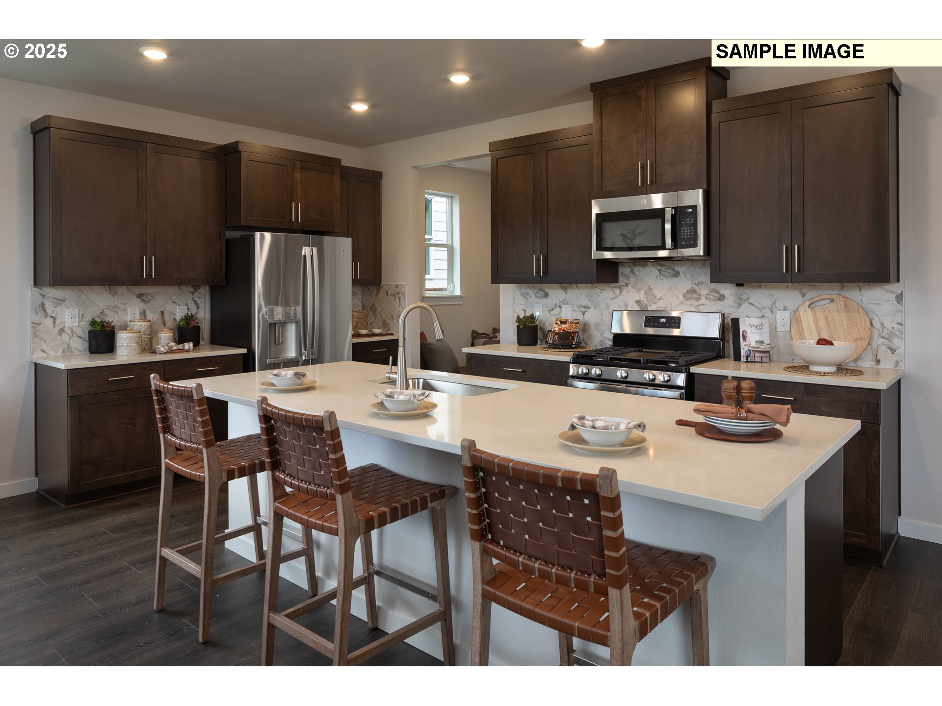 3777 Southwest 37th Street Gresham, OR 97080 - Photo 4 of 12 a kitchen with stainless steel appliances a sink a stove a refrigerator cabinets and a dining table