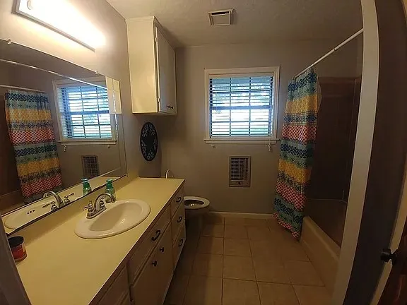 a bedroom with a bed wooden floor and a window