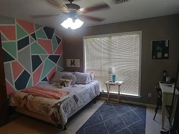 a bedroom with bed and window