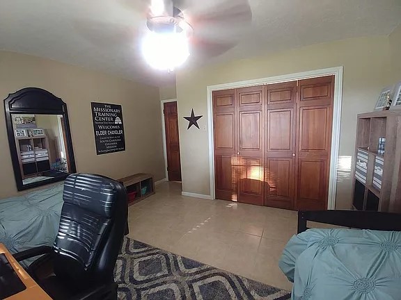 105 Red Tip Lane Brenham, TX 77833 - Photo 24 of 40 a bedroom with a bed and wooden floor