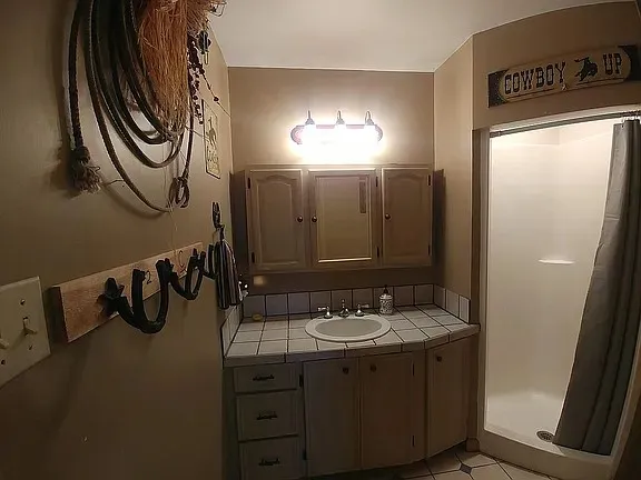 a backyard of a house with barbeque oven table and chairs