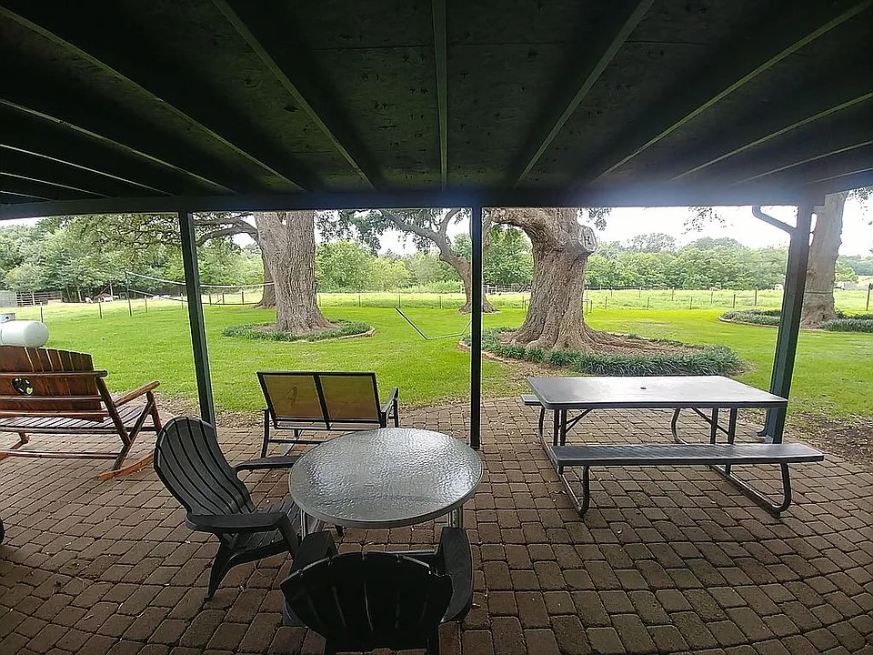 105 Red Tip Lane Brenham, TX 77833 - Photo 26 of 40 a view of chairs and table in patio with wooden fence